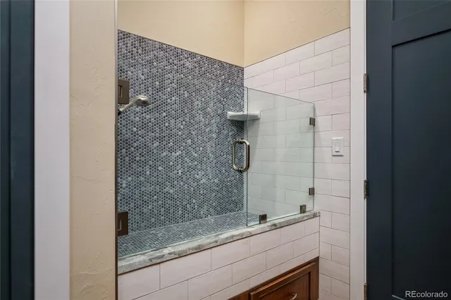 a bathroom with a shower and a sink