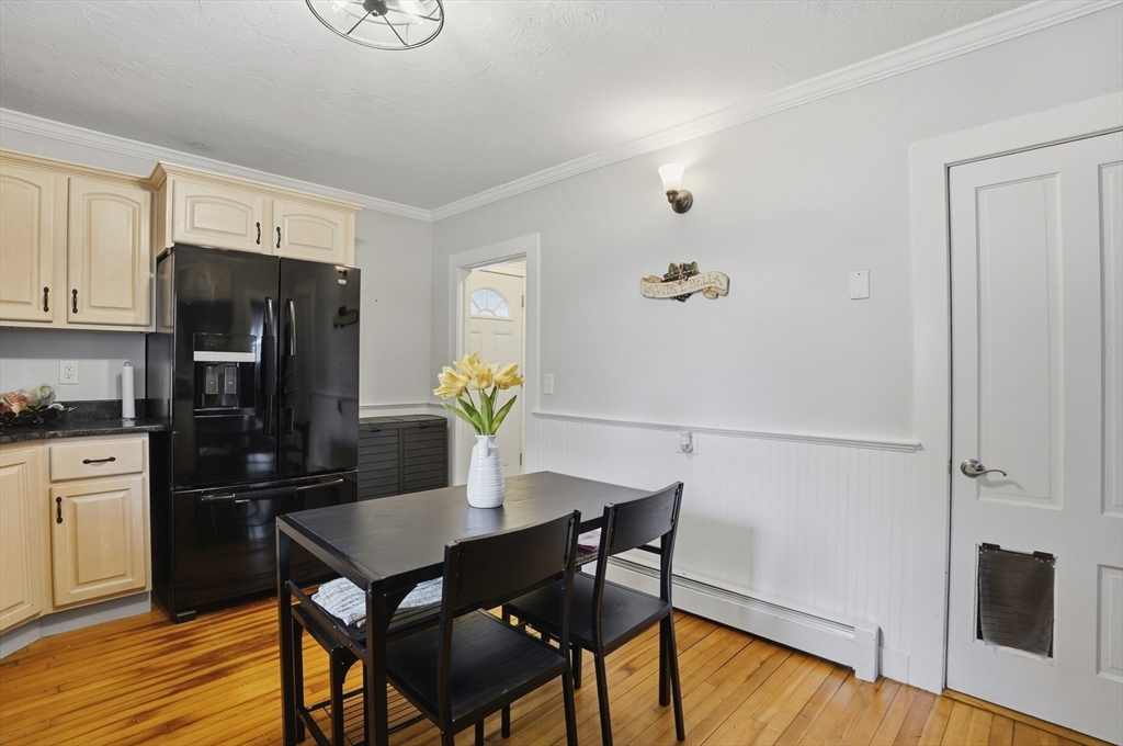 23 Dryden Street Worcester, MA 01605 - Photo 12 of 29 a kitchen with a table chairs and refrigerator