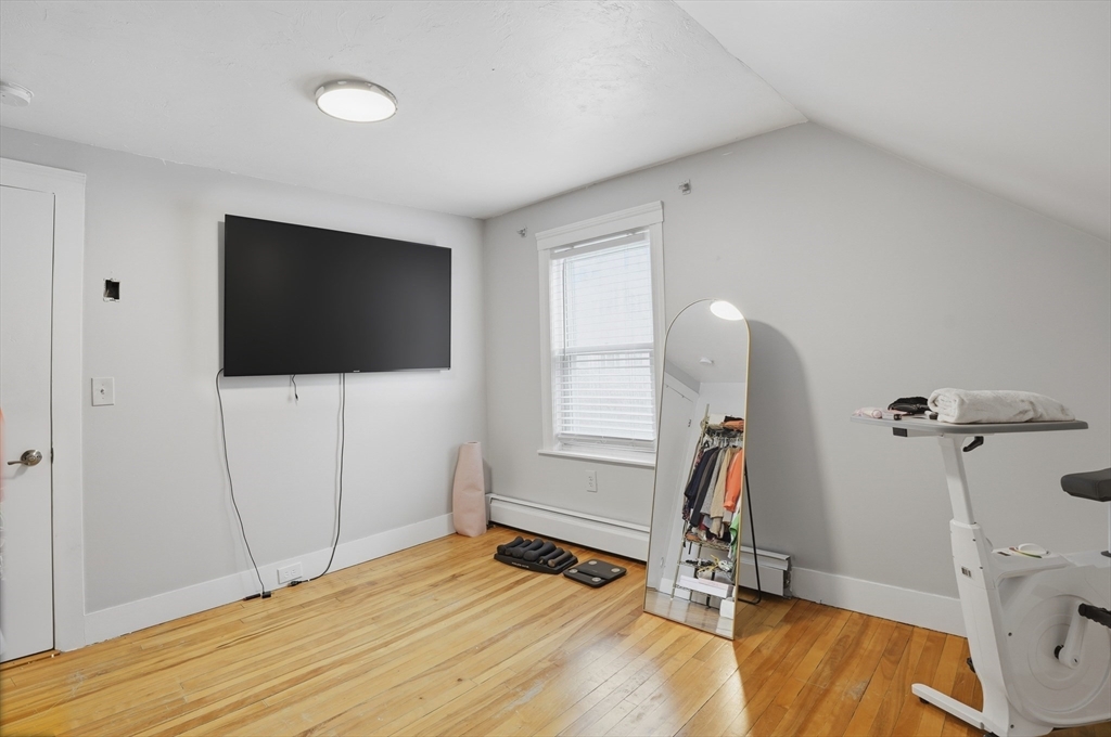 23 Dryden Street Worcester, MA 01605 - Photo 17 of 29 a view of a room with gym equipment and a flat screen tv