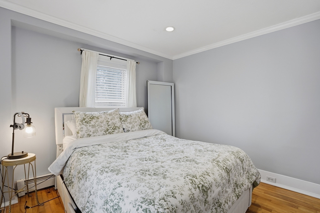 23 Dryden Street Worcester, MA 01605 - Photo 22 of 29 a bedroom with a bed and wooden floor