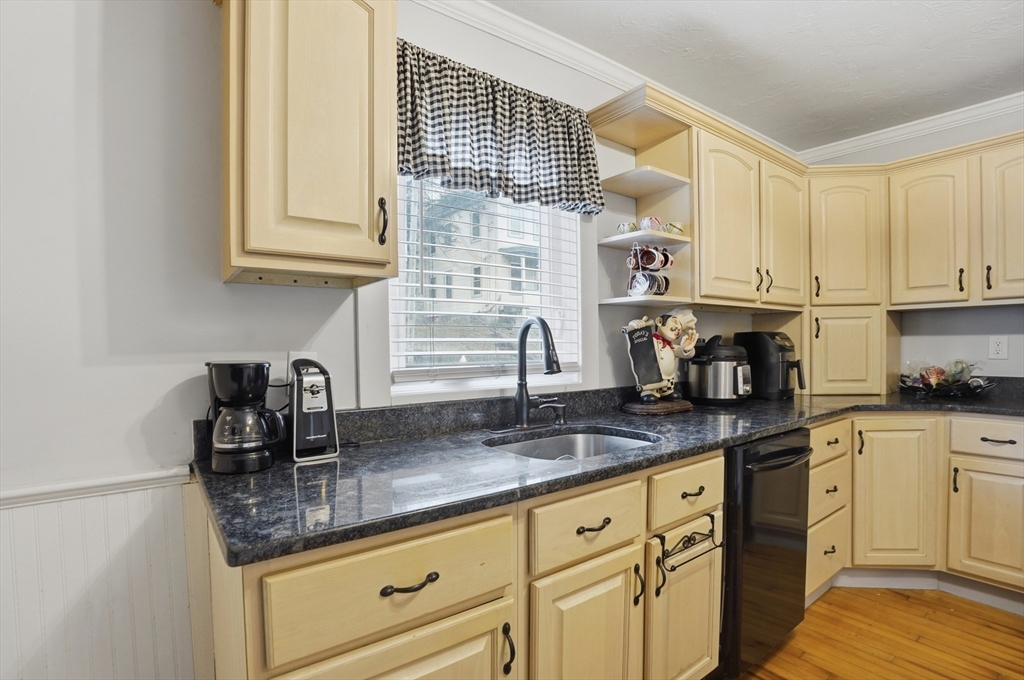 23 Dryden Street Worcester, MA 01605 - Photo 10 of 29 a kitchen with stainless steel appliances granite countertop a sink a stove and cabinets