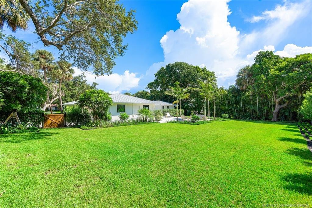 9 Mandalay Road Stuart, FL 34996 - Photo 42 of 44 a front view of a house with garden