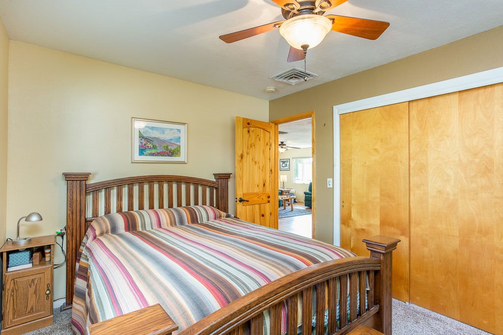 3596 G Road Palisade, CO 81526 - Photo 8 of 42 a bedroom with a bed and a chandelier