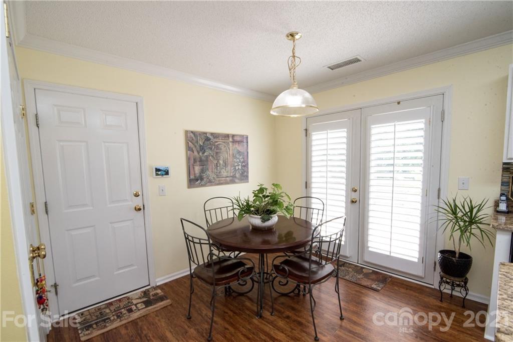 11427 Gold Pan Road Charlotte, NC 28215 - Photo 12 of 34 a view of a dining room with furniture window and wooden floor