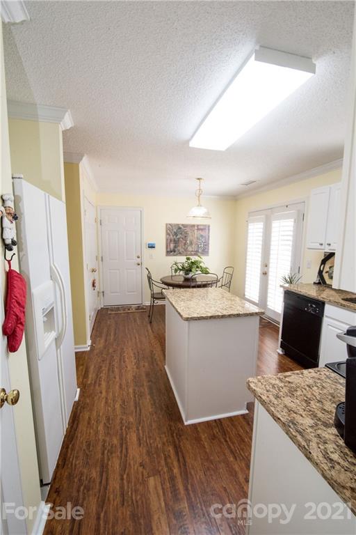 11427 Gold Pan Road Charlotte, NC 28215 - Photo 13 of 34 a kitchen with granite countertop a refrigerator a stove top oven a sink and dishwasher