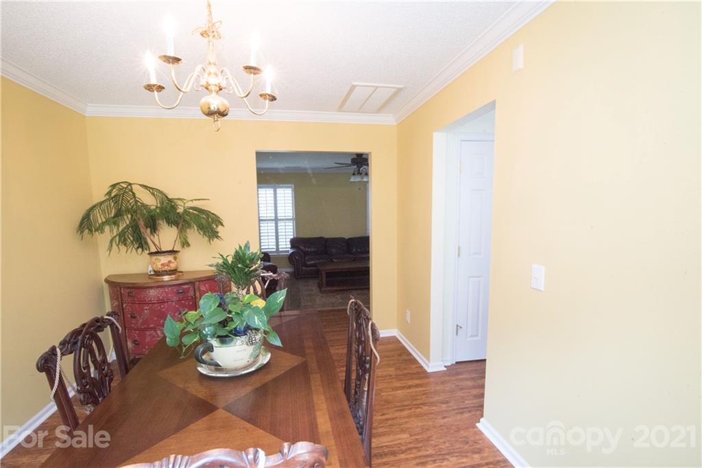 11427 Gold Pan Road Charlotte, NC 28215 - Photo 14 of 34 a view of a dining room with furniture and a chandelier