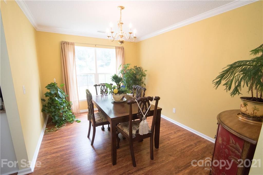 11427 Gold Pan Road Charlotte, NC 28215 - Photo 15 of 34 a view of a dining room with furniture and chandelier