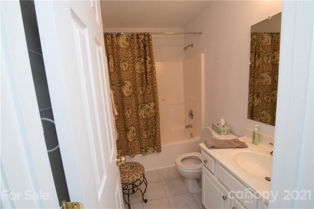 11427 Gold Pan Road Charlotte, NC 28215 - Photo 24 of 34 a bathroom with a granite countertop sink toilet and shower