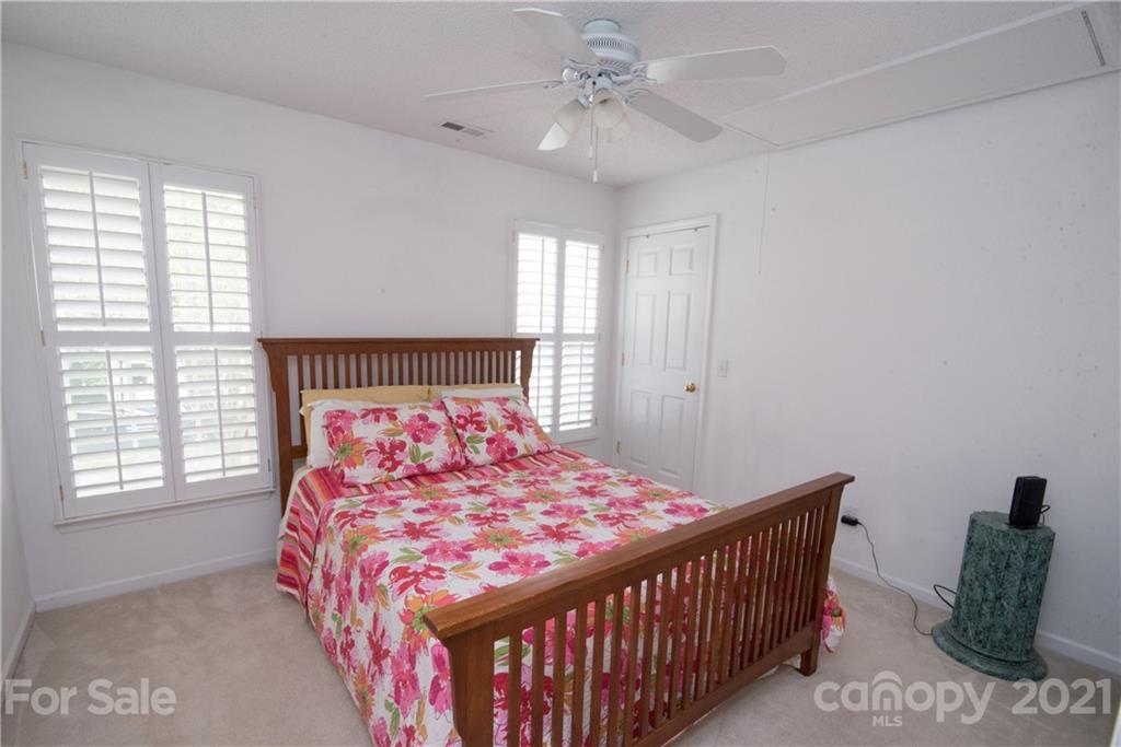 11427 Gold Pan Road Charlotte, NC 28215 - Photo 25 of 34 a bedroom with a bed and a window