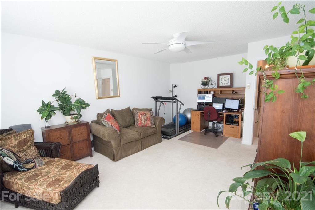 11427 Gold Pan Road Charlotte, NC 28215 - Photo 28 of 34 a living room with furniture and a chandelier