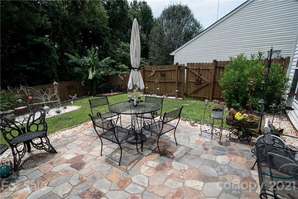 11427 Gold Pan Road Charlotte, NC 28215 - Photo 30 of 34 a view of patio with table and chairs and potted plants