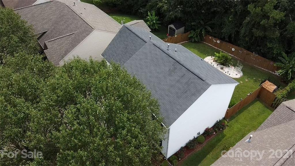 11427 Gold Pan Road Charlotte, NC 28215 - Photo 4 of 34 an aerial view of a house with a yard and trees all around