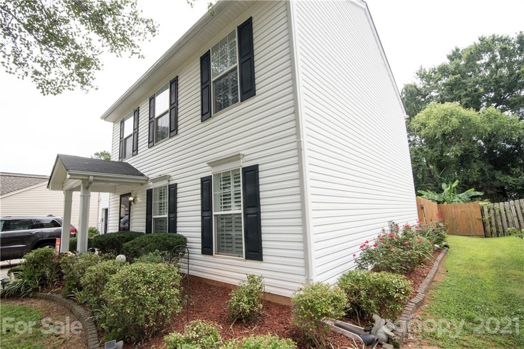 11427 Gold Pan Road Charlotte, NC 28215 - Photo 5 of 34 a view of a white house next to a yard