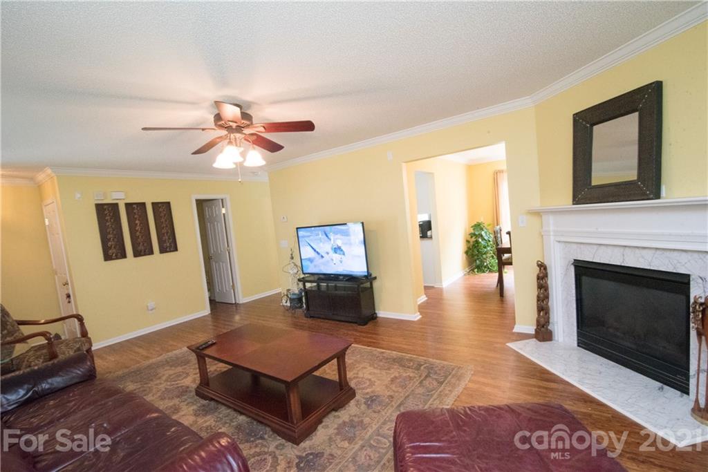 11427 Gold Pan Road Charlotte, NC 28215 - Photo 8 of 34 a living room with furniture and a fireplace