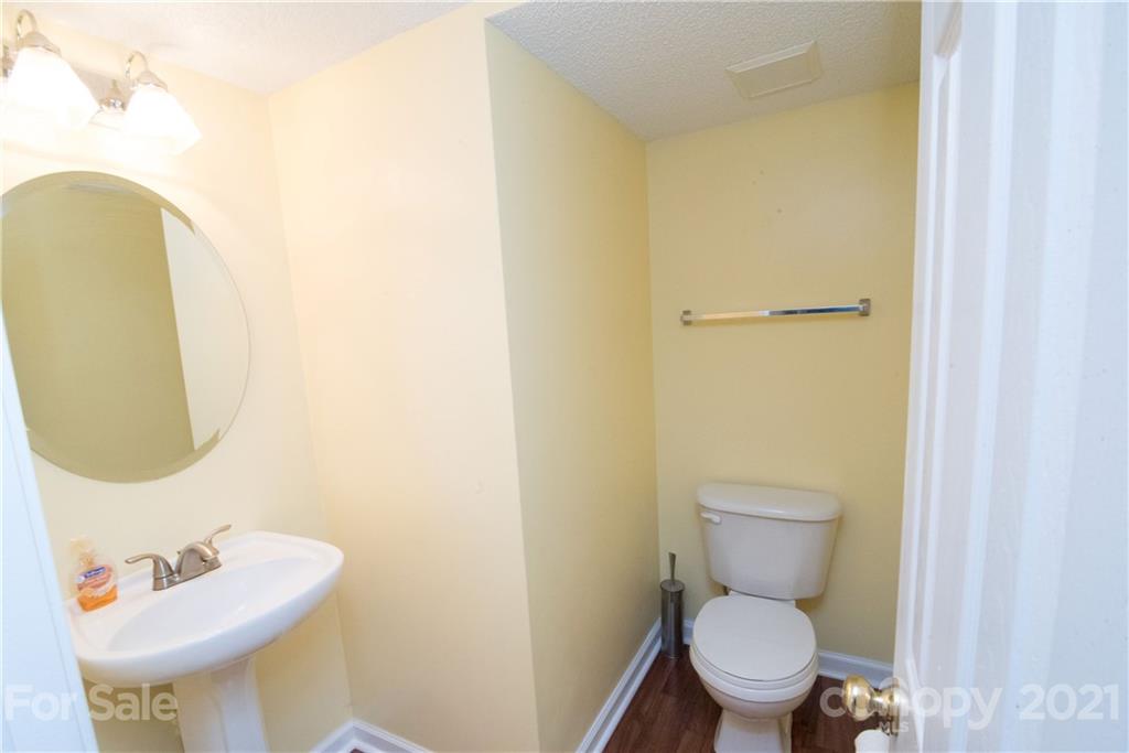 11427 Gold Pan Road Charlotte, NC 28215 - Photo 9 of 34 a white toilet sitting next to a bathroom sink
