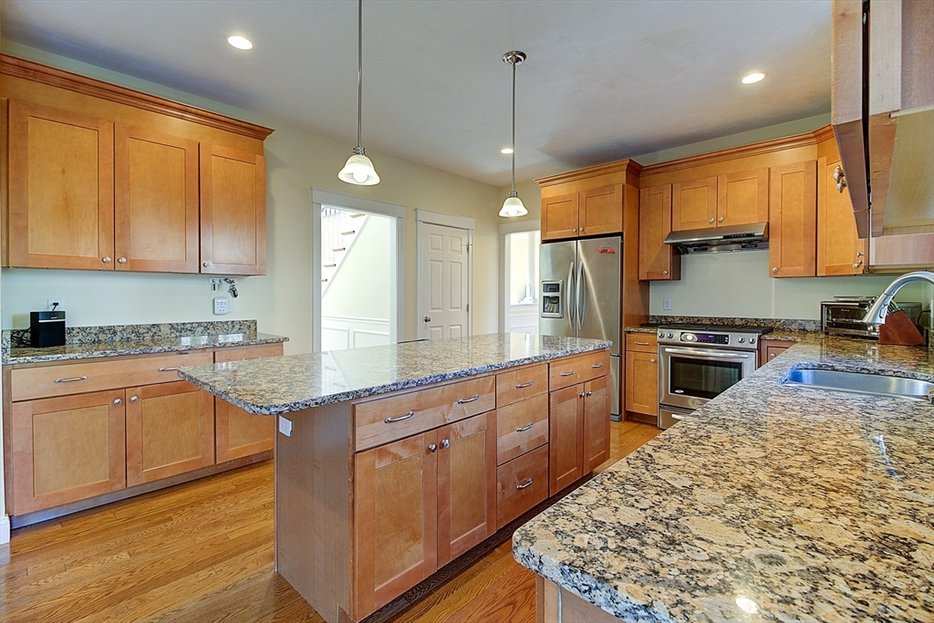 143 Potter Road Framingham, MA 01701 - Photo 15 of 42 a kitchen with stainless steel appliances granite countertop a stove a sink a center island and a window
