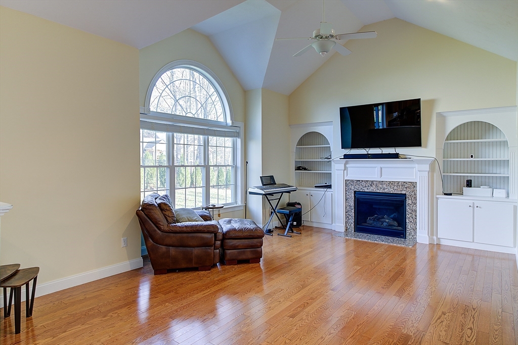 143 Potter Road Framingham, MA 01701 - Photo 18 of 42 a living room with furniture a fireplace and a flat screen tv