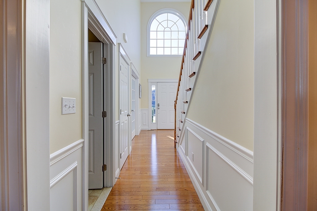 143 Potter Road Framingham, MA 01701 - Photo 20 of 42 a view of a hallway with wooden floor and staircase
