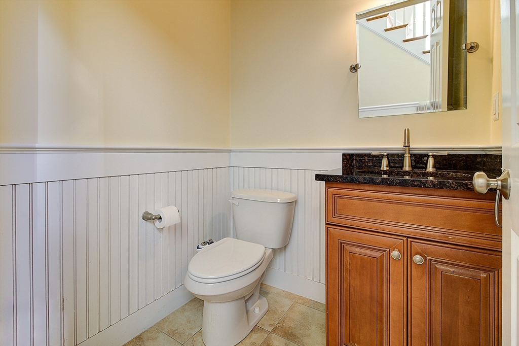 143 Potter Road Framingham, MA 01701 - Photo 21 of 42 a bathroom with a toilet a sink and vanity