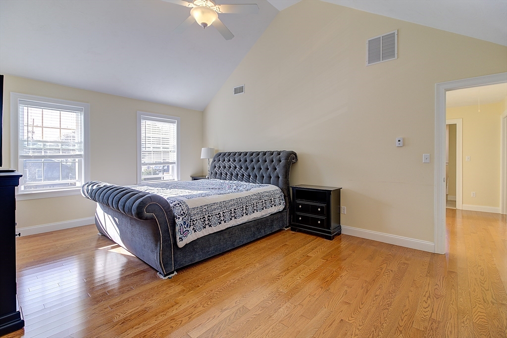 143 Potter Road Framingham, MA 01701 - Photo 25 of 42 a spacious bedroom with a bed and wooden floor
