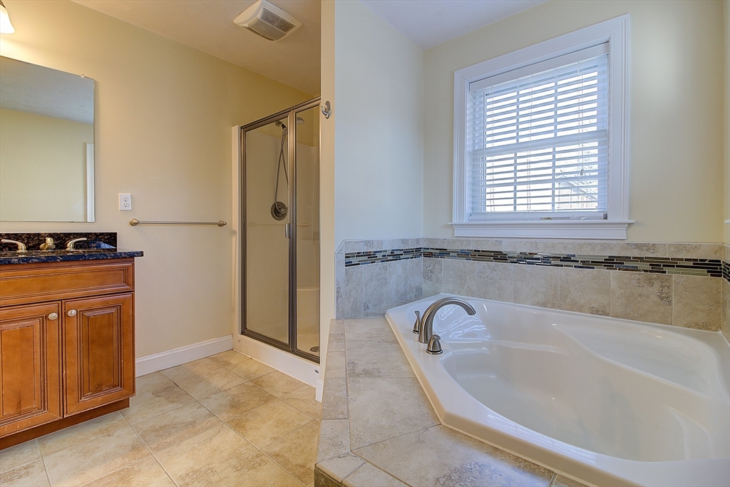 143 Potter Road Framingham, MA 01701 - Photo 27 of 42 a bath tub sitting in a bathroom next to a window