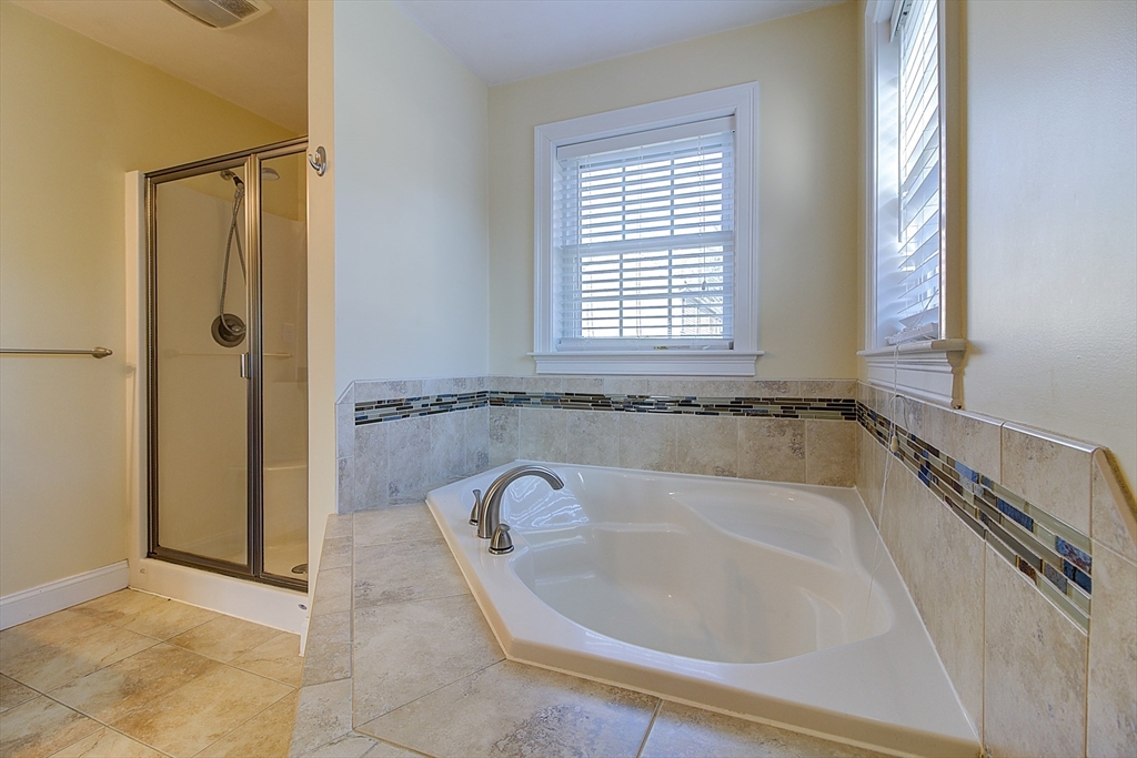143 Potter Road Framingham, MA 01701 - Photo 28 of 42 a bath tub sitting in a bathroom next to a window