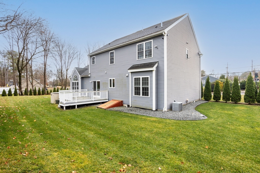 143 Potter Road Framingham, MA 01701 - Photo 39 of 42 a white house sitting in the middle of a yard