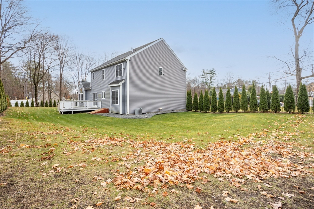 143 Potter Road Framingham, MA 01701 - Photo 40 of 42 a large house with a big yard and large trees