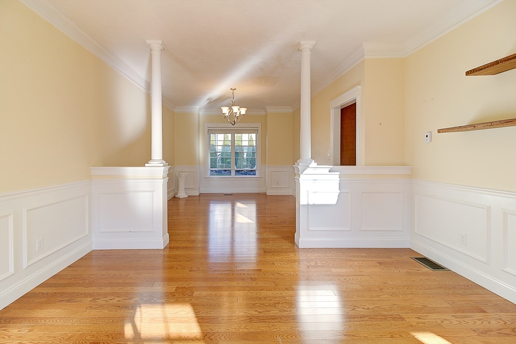 143 Potter Road Framingham, MA 01701 - Photo 9 of 42 a view of empty room with wooden floor and fan