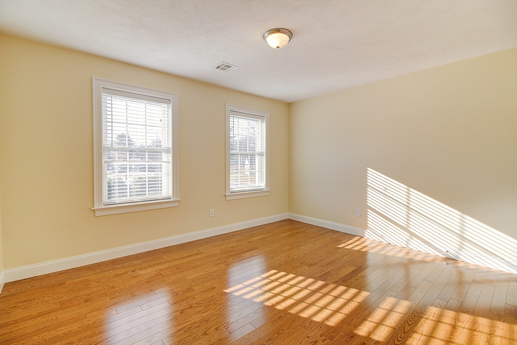 143 Potter Road Framingham, MA 01701 - Photo 10 of 42 a view of an empty room with wooden floor and a window