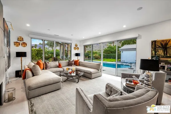 a living room with furniture and a large window