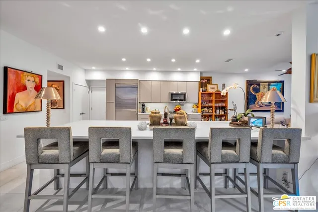 a view of a kitchen and dining area in the background