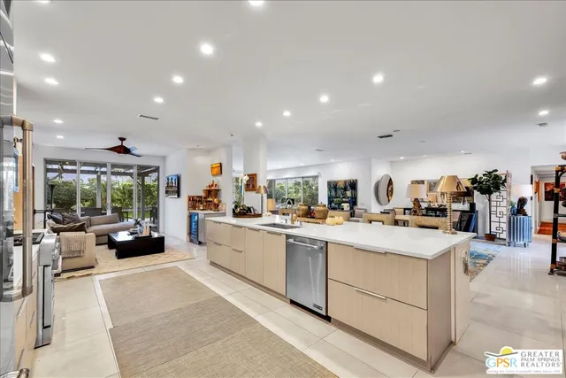 a large kitchen with stainless steel appliances granite countertop a lot of counter space and wooden floors