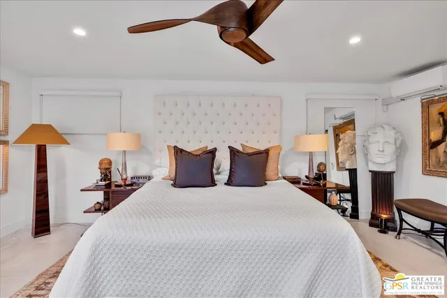 a bed room with a bed and a view of living room