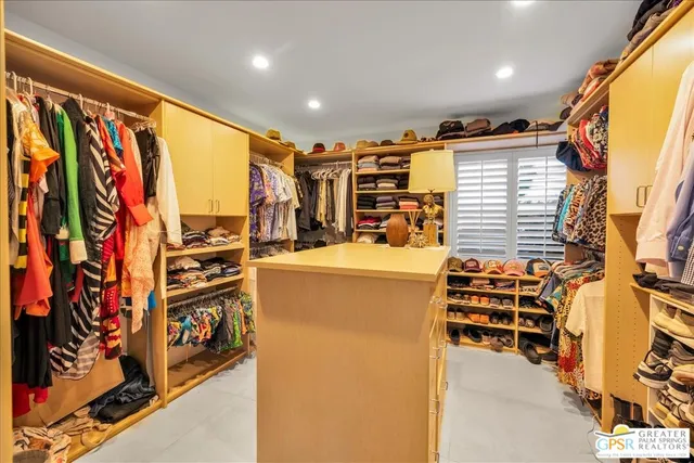 a living room with a rug and a open kitchen