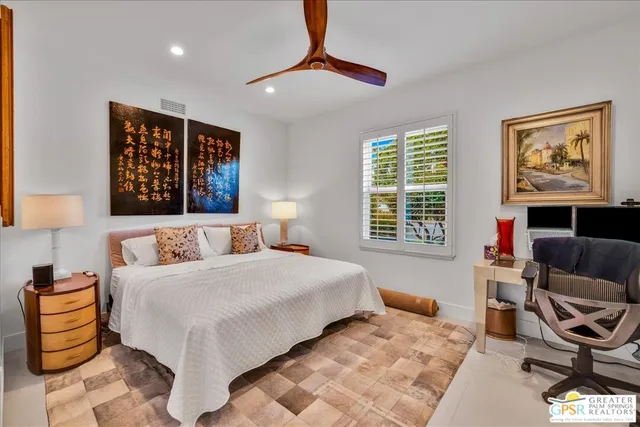 a bedroom with a bed and a chair with the outer view