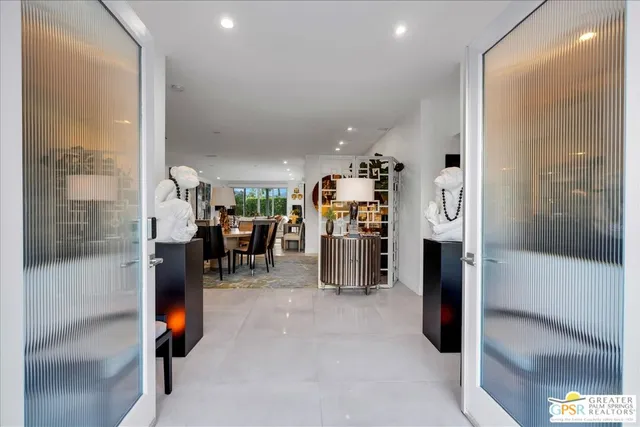 a kitchen with stainless steel appliances kitchen island granite countertop a refrigerator and a sink
