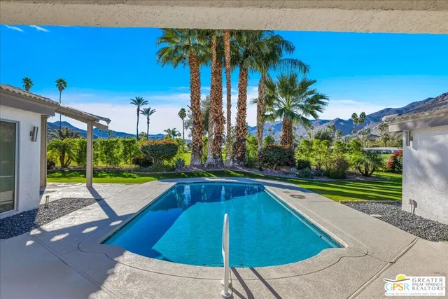 a view of a house with swimming pool and porch