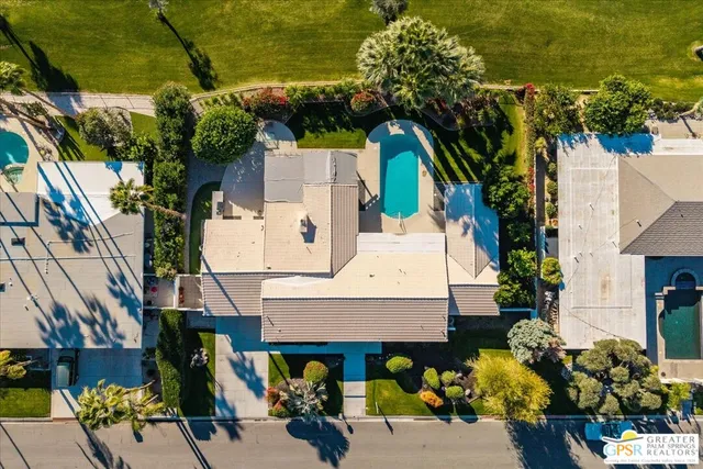 a view of a swimming pool with a yard
