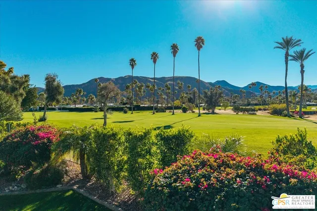a view of a patio with a table chairs and a backyard