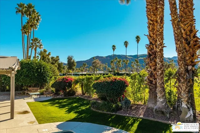 a view of a patio with table and chairs potted plants with wooden floor and fence