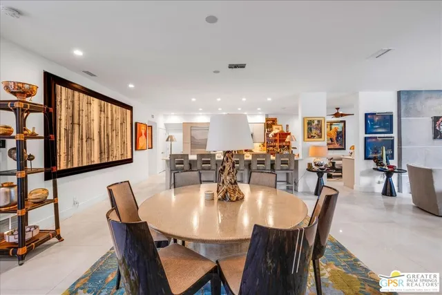 a kitchen with stainless steel appliances kitchen island granite countertop a refrigerator and microwave