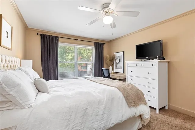 a bedroom with a large bed and a chandelier