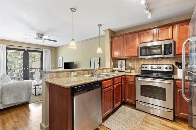 a kitchen with a sink stove and microwave