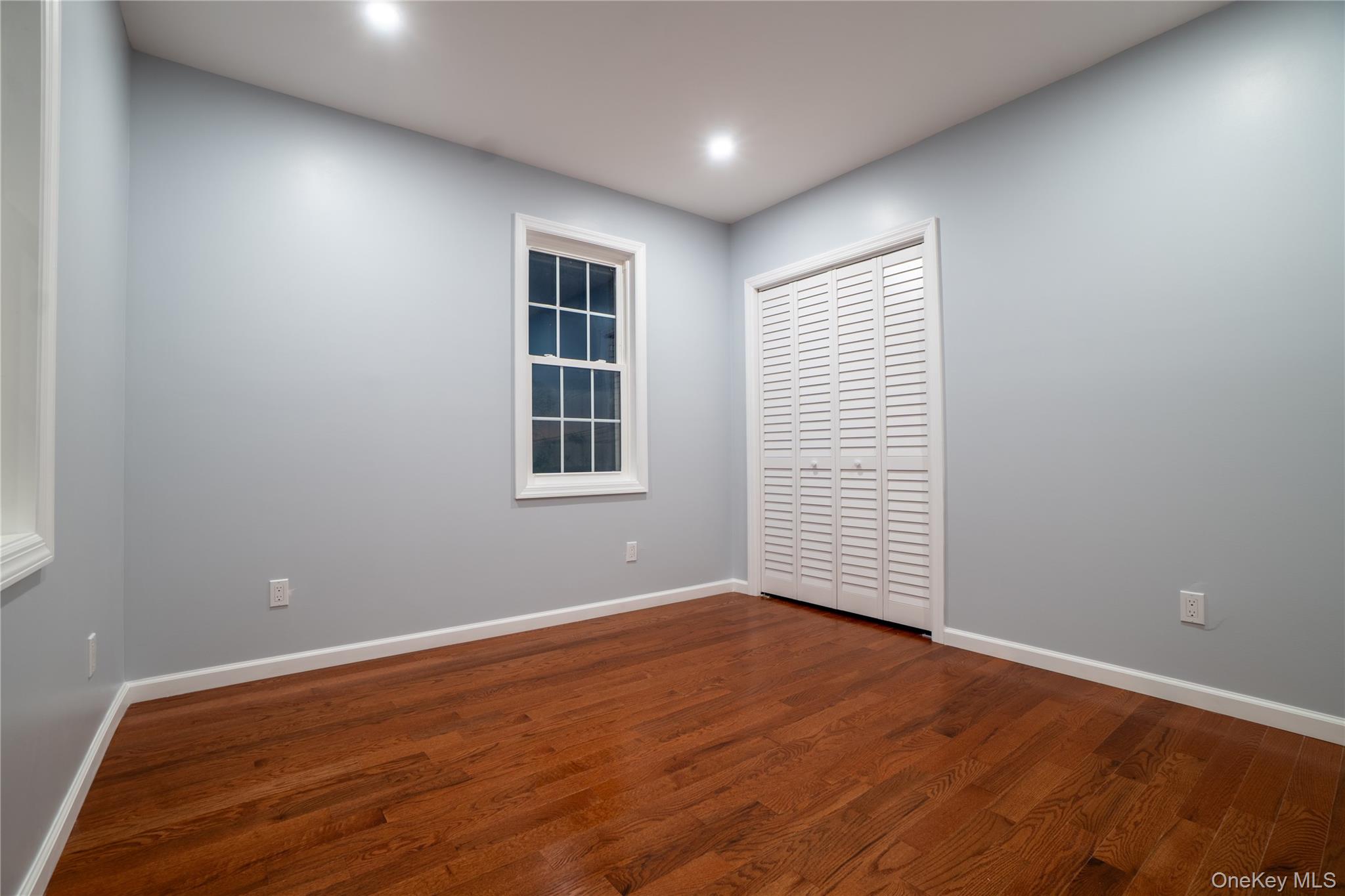 139 Maple Avenue Bethpage, NY 11714 - Photo 19 of 25 Unfurnished bedroom with dark wood-type flooring, a closet, and recessed lighting