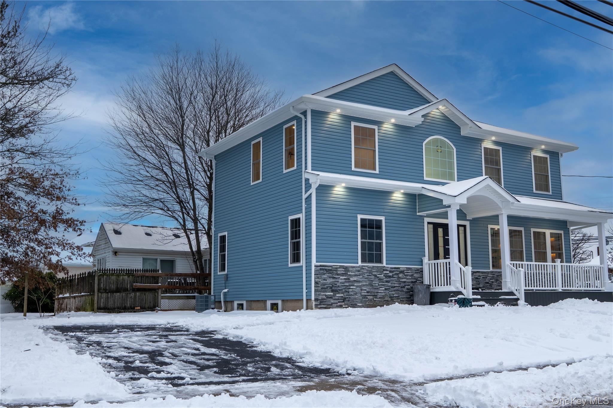 139 Maple Avenue Bethpage, NY 11714 - Photo 2 of 25 View of front facade with a porch and stone siding