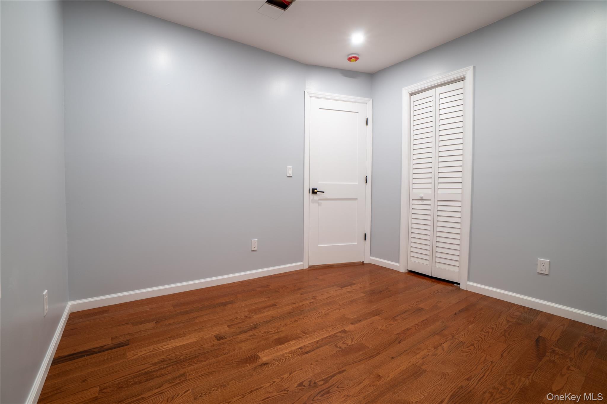 139 Maple Avenue Bethpage, NY 11714 - Photo 21 of 25 Empty room featuring dark wood-type flooring