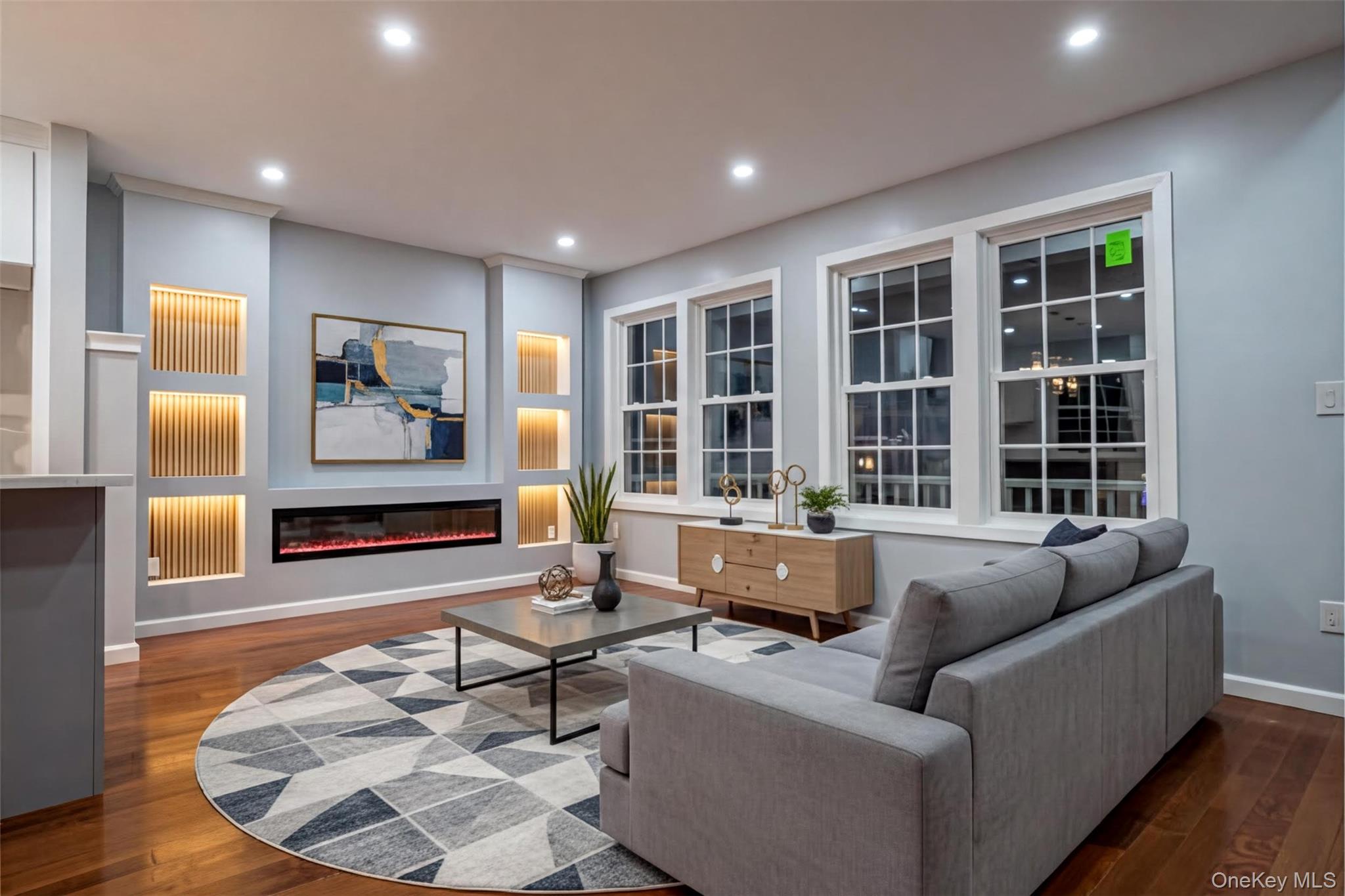 139 Maple Avenue Bethpage, NY 11714 - Photo 5 of 25 Living room featuring a glass covered fireplace, recessed lighting, and dark wood finished floors