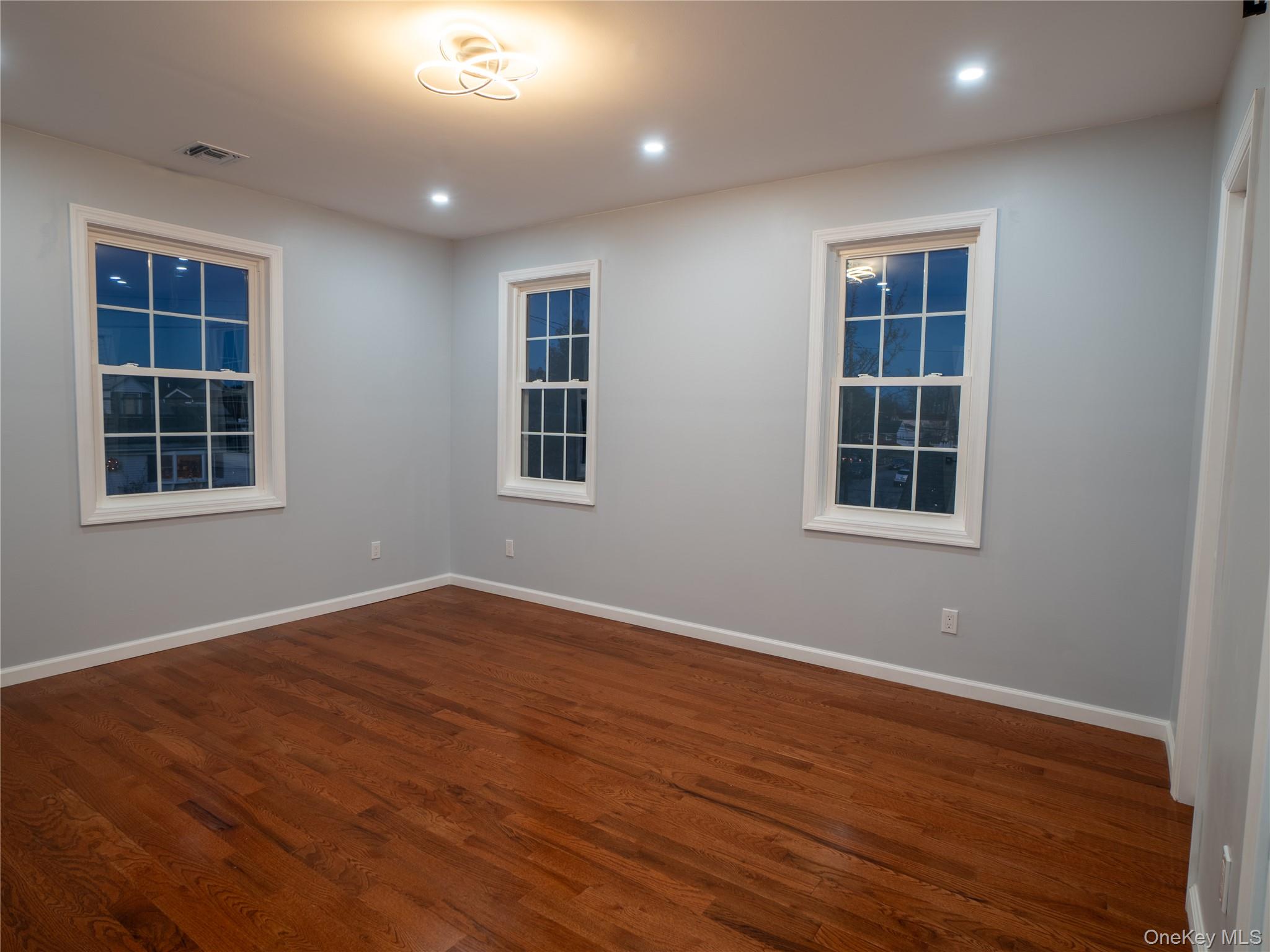 139 Maple Avenue Bethpage, NY 11714 - Photo 10 of 25 Unfurnished room with dark wood-style floors and recessed lighting