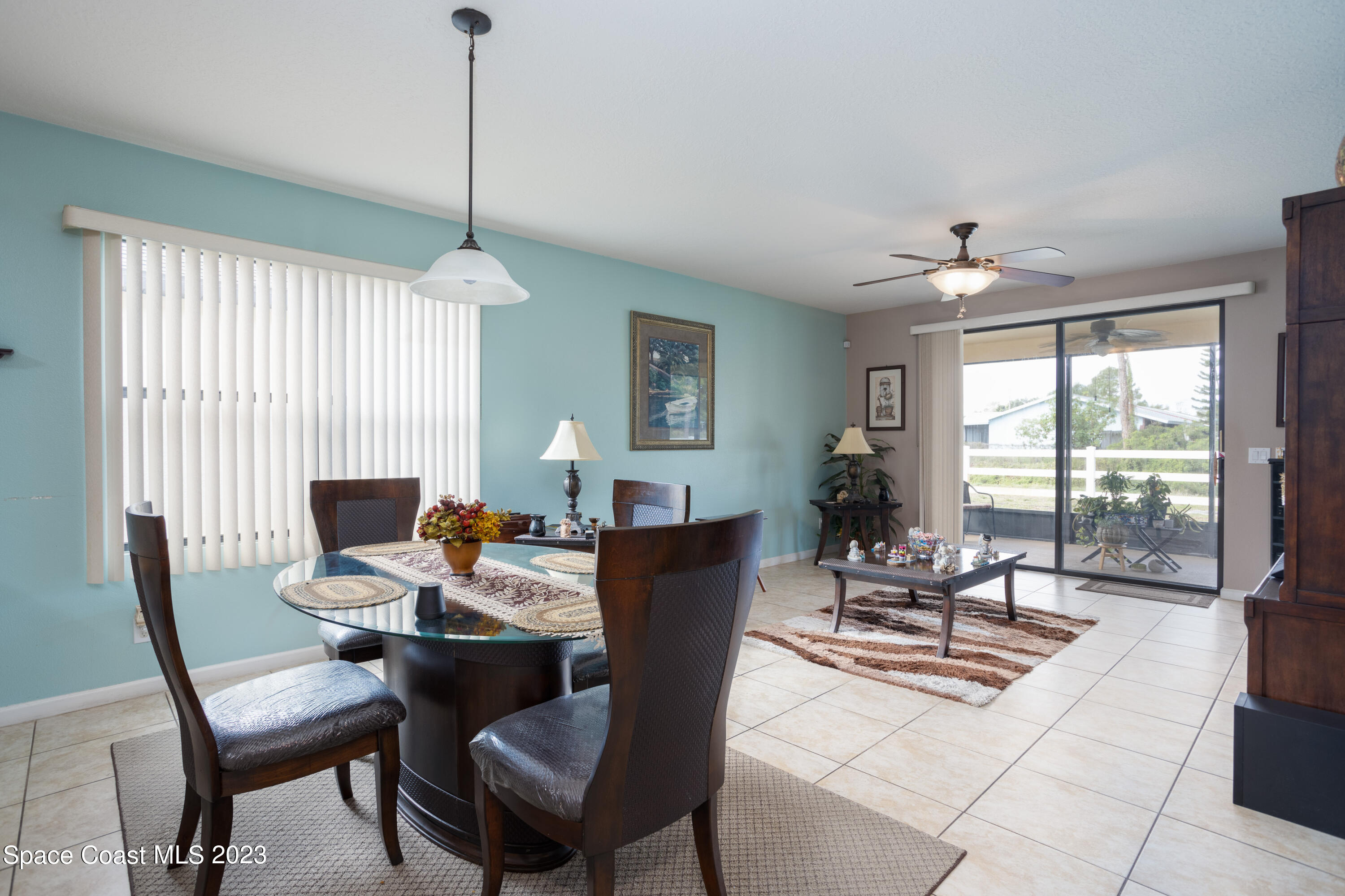 4130 Millicent Circle Melbourne, FL 32901 - Photo 13 of 28 a living room with furniture a flat screen tv and a large window